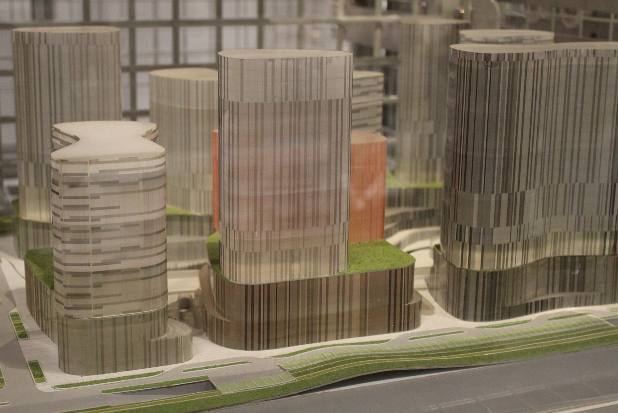 Close-up of an architectural model of a mixed-use tower complex with landscaped podiums